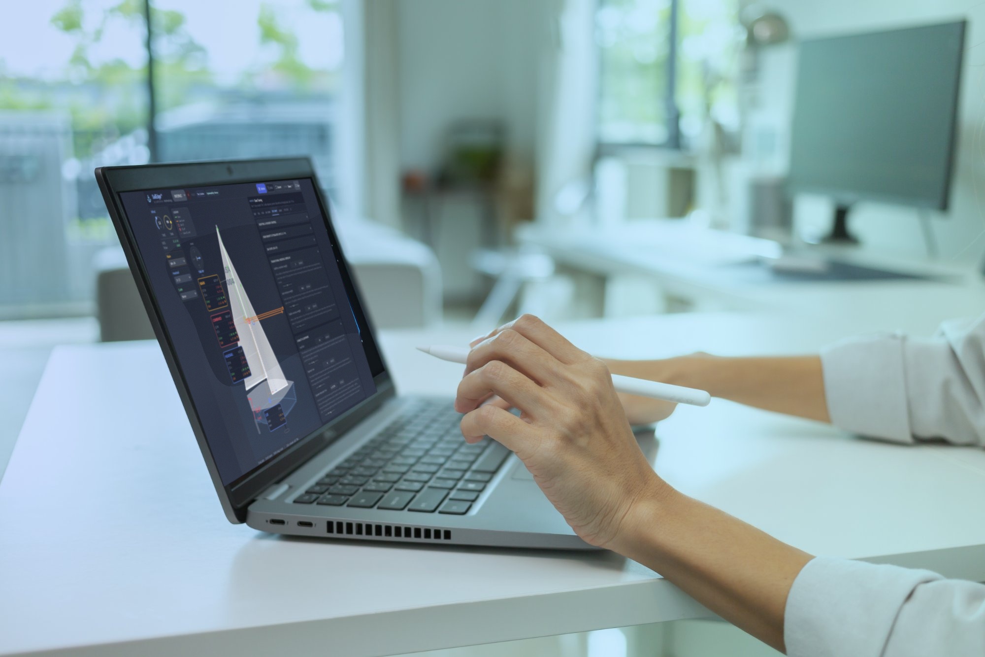 Engineer analyzing performance curves on laptop screen